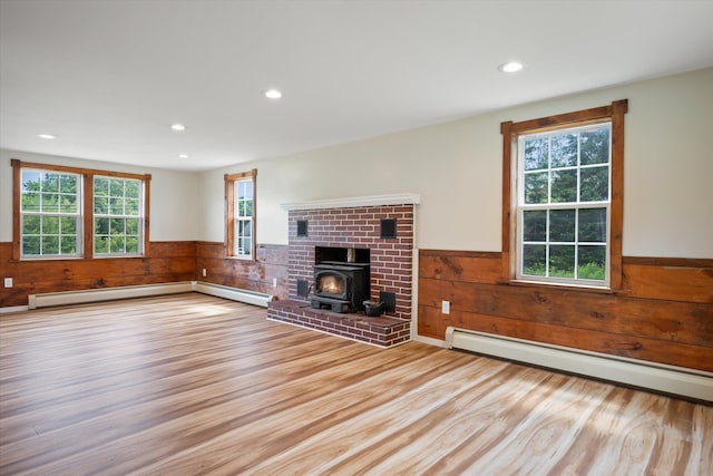 24 Blackswoods Rd, Franklin, ME 04634 - unfurnished living room with wainscoting, baseboard heating, wood finished floors, recessed lighting, and a wood stove