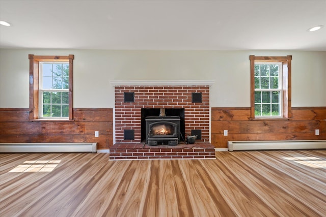 24 Blackswoods Rd, Franklin, ME 04634 - unfurnished living room featuring a baseboard radiator, a wainscoted wall, wood finished floors, healthy amount of natural light, and recessed lighting