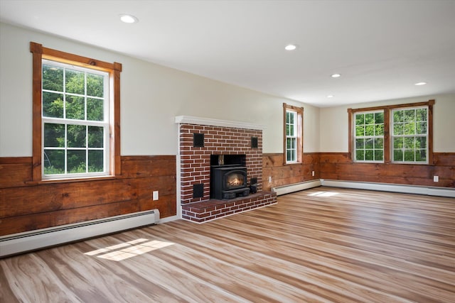 24 Blackswoods Rd, Franklin, ME 04634 - unfurnished living room with wainscoting, wood finished floors, baseboard heating, wood walls, and recessed lighting