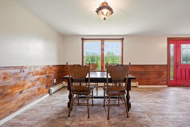 24 Blackswoods Rd, Franklin, ME 04634 - dining room featuring a baseboard radiator, wainscoting, wood walls, and stone finish flooring