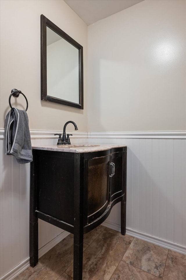 24 Blackswoods Rd, Franklin, ME 04634 - bathroom featuring a wainscoted wall and vanity