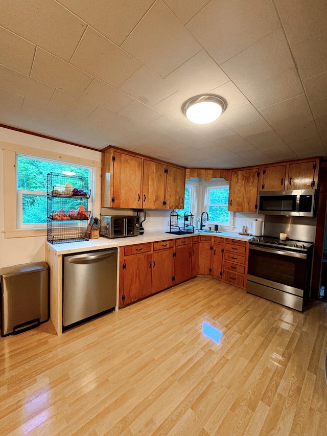 429 Rte 3, Palermo, ME 04354 - kitchen featuring stainless steel appliances, light countertops, brown cabinets, and light wood finished floors