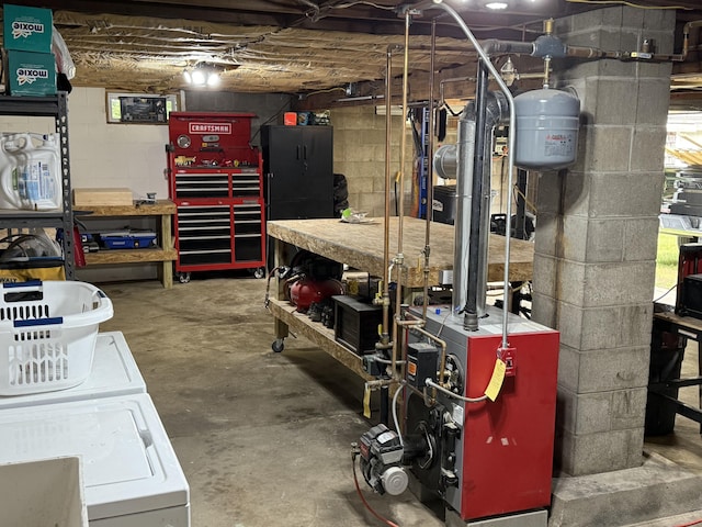 429 Rte 3, Palermo, ME 04354 - below grade area featuring a workshop area, washing machine and dryer, concrete block wall, and a heating unit