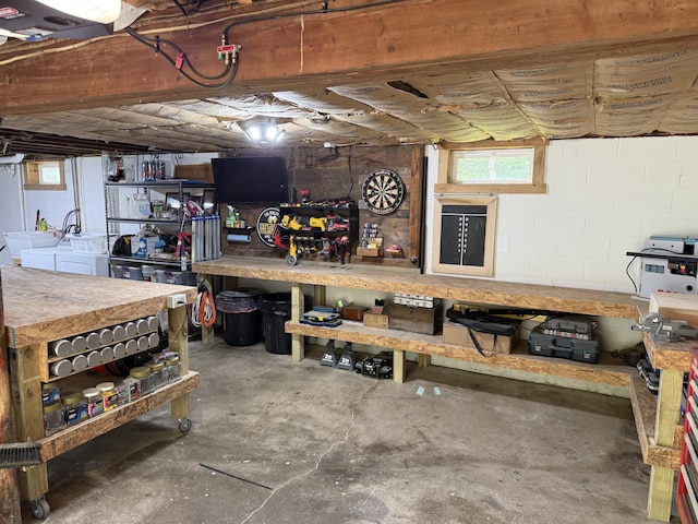 429 Rte 3, Palermo, ME 04354 - below grade area with a workshop area, washing machine and clothes dryer, concrete block wall, and healthy amount of natural light