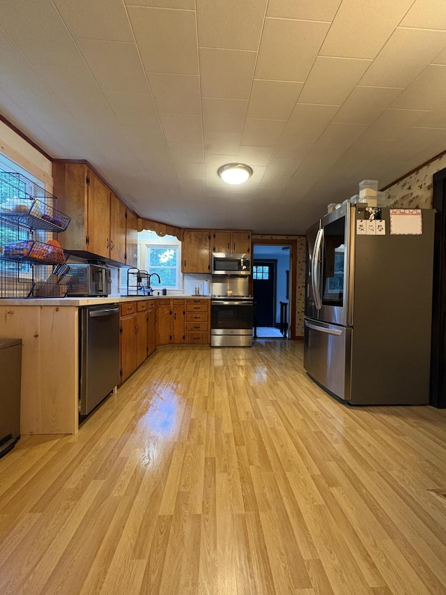 429 Rte 3, Palermo, ME 04354 - kitchen featuring stainless steel appliances, brown cabinets, light wood-style flooring, and light countertops