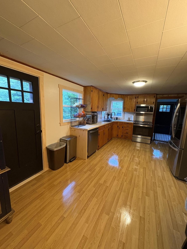 429 Rte 3, Palermo, ME 04354 - kitchen with appliances with stainless steel finishes, brown cabinetry, light wood-type flooring, light countertops, and plenty of natural light