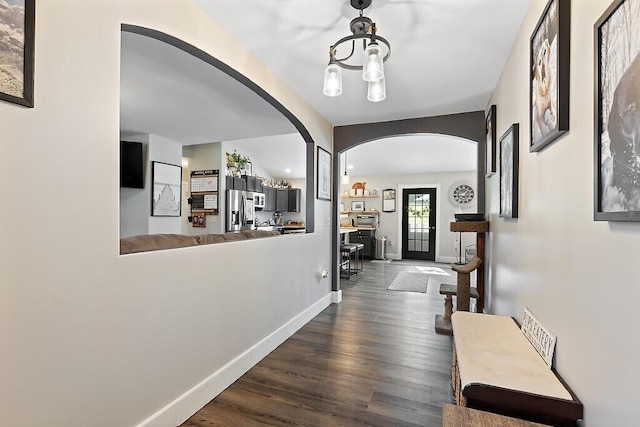 15 Fieldstone Dr, Augusta, ME 04330 - hallway with arched walkways, wood finished floors, and a chandelier