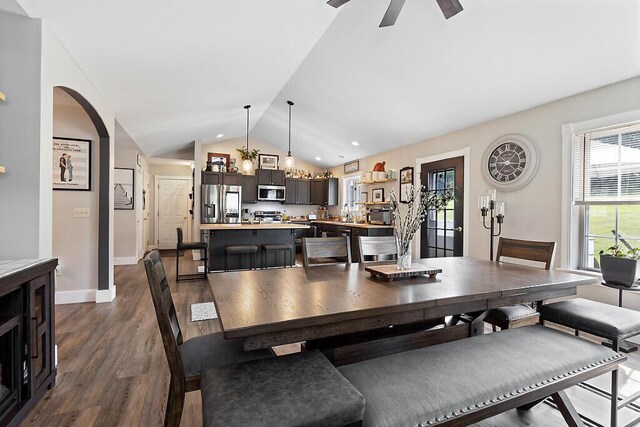 15 Fieldstone Dr, Augusta, ME 04330 - dining room featuring lofted ceiling, dark wood-style flooring, arched walkways, and a ceiling fan