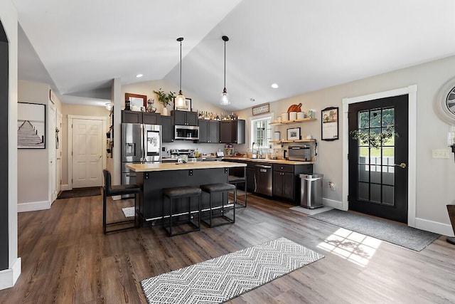 15 Fieldstone Dr, Augusta, ME 04330 - kitchen with appliances with stainless steel finishes, light countertops, a breakfast bar area, vaulted ceiling, and a kitchen island