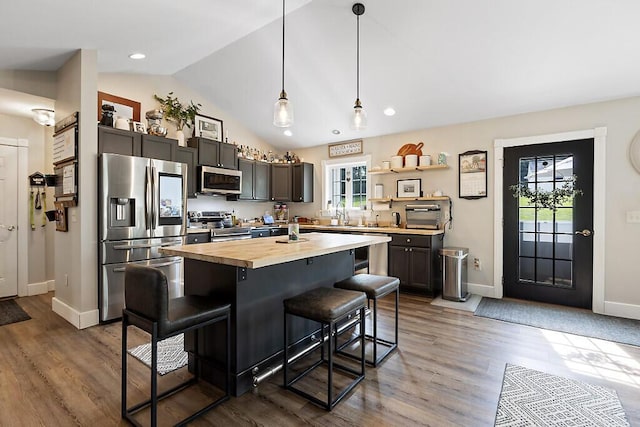 15 Fieldstone Dr, Augusta, ME 04330 - kitchen with stainless steel appliances, butcher block counters, a breakfast bar area, plenty of natural light, and lofted ceiling