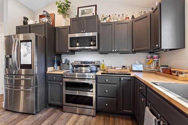 15 Fieldstone Dr, Augusta, ME 04330 - kitchen featuring stainless steel appliances, wood finished floors, light countertops, and lofted ceiling