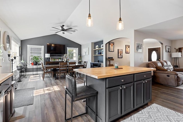15 Fieldstone Dr, Augusta, ME 04330 - kitchen with open floor plan, wood counters, arched walkways, ceiling fan, and dark wood-style flooring