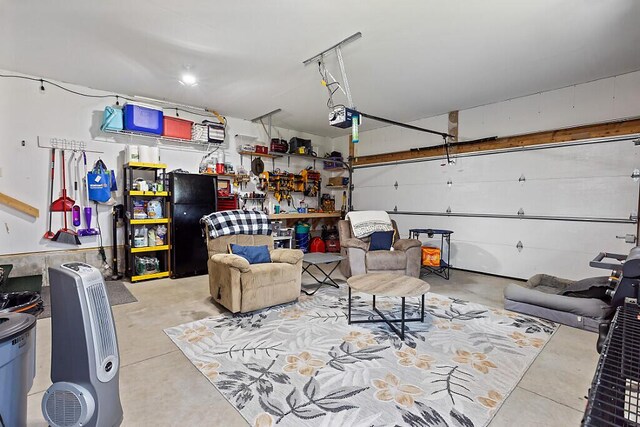 15 Fieldstone Dr, Augusta, ME 04330 - garage featuring a garage door opener and freestanding refrigerator
