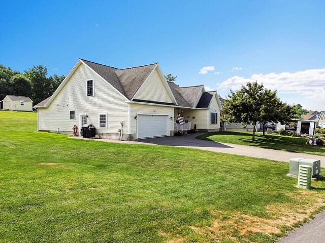 15 Fieldstone Dr, Augusta, ME 04330 - view of home's exterior featuring driveway, a yard, and a garage