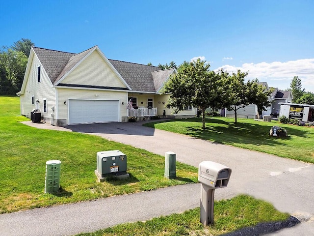 15 Fieldstone Dr, Augusta, ME 04330 - traditional-style house featuring asphalt driveway, a garage, and a front yard