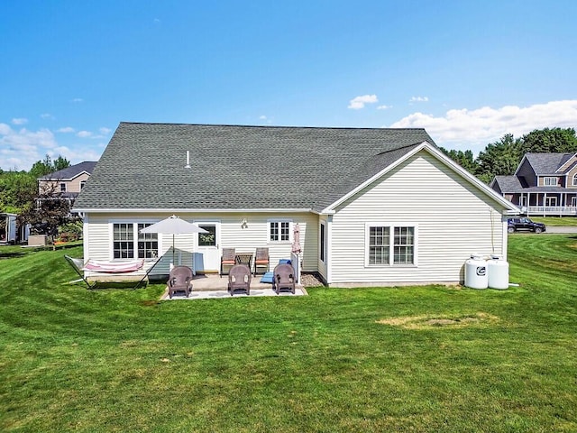 15 Fieldstone Dr, Augusta, ME 04330 - back of house with a patio area, a lawn, and a shingled roof