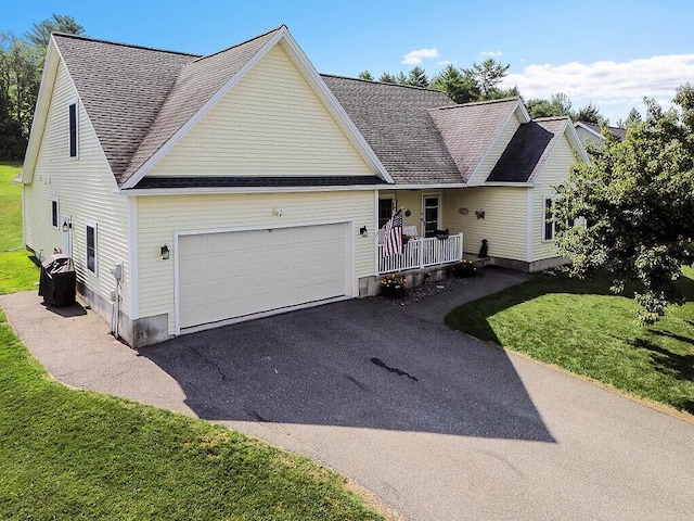 15 Fieldstone Dr, Augusta, ME 04330 - traditional home featuring a garage, asphalt driveway, roof with shingles, and a front lawn
