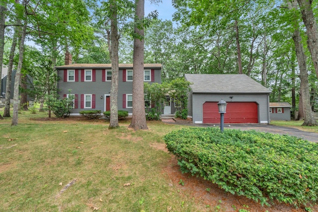 14 Pinewood Cir, Biddeford, ME 04005 - colonial-style house with a chimney, driveway, a garage, and a front yard