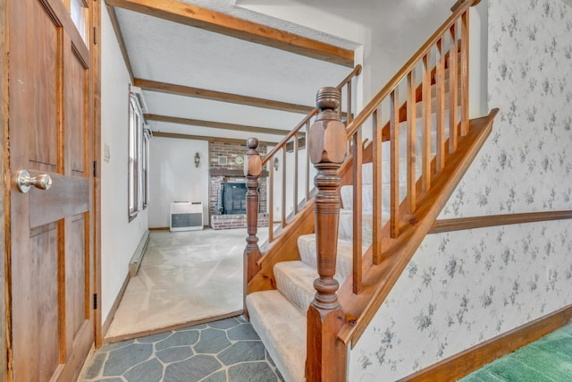 14 Pinewood Cir, Biddeford, ME 04005 - staircase featuring beamed ceiling, carpet flooring, heating unit, wallpapered walls, and a fireplace