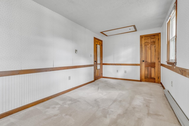 14 Pinewood Cir, Biddeford, ME 04005 - unfurnished room with attic access, baseboard heating, carpet flooring, and a wainscoted wall