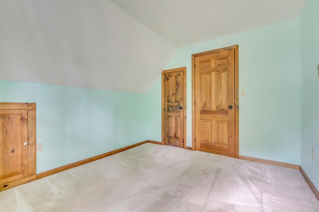 14 Pinewood Cir, Biddeford, ME 04005 - carpeted empty room featuring vaulted ceiling and baseboards