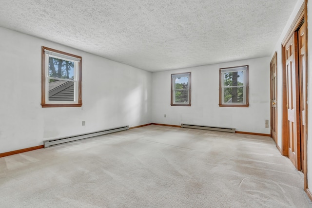 14 Pinewood Cir, Biddeford, ME 04005 - unfurnished bedroom featuring a baseboard heating unit, multiple windows, carpet, and a textured ceiling