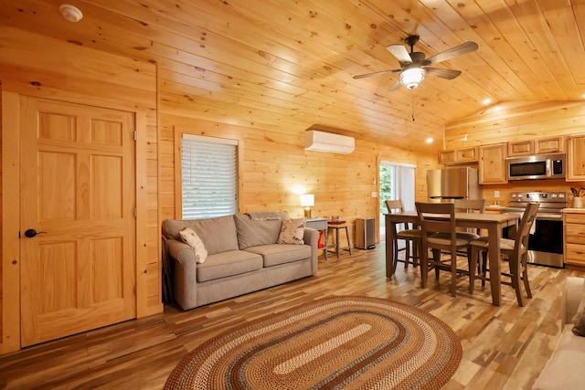 92 Cottage Shore Dr, Holden, ME 04429 - living room featuring lofted ceiling, wood ceiling, a ceiling fan, light wood-style floors, and wood walls