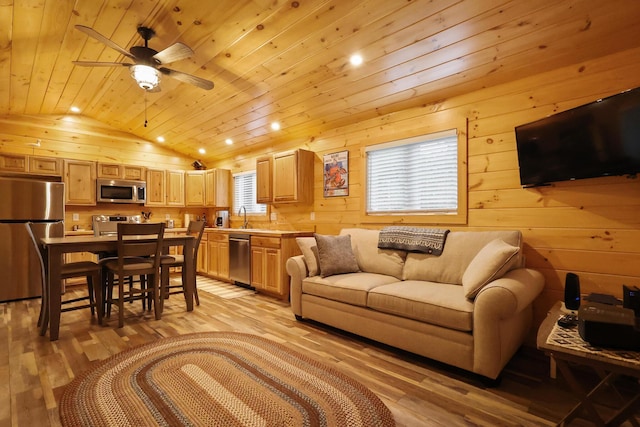 92 Cottage Shore Dr, Holden, ME 04429 - living room with lofted ceiling, wooden ceiling, light wood finished floors, wood walls, and a ceiling fan