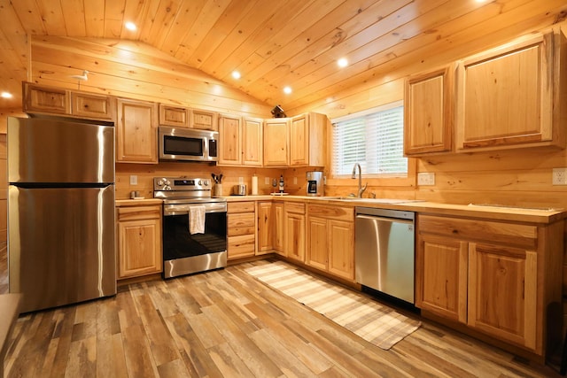 92 Cottage Shore Dr, Holden, ME 04429 - kitchen with appliances with stainless steel finishes, wood ceiling, vaulted ceiling, light wood-style floors, and light countertops