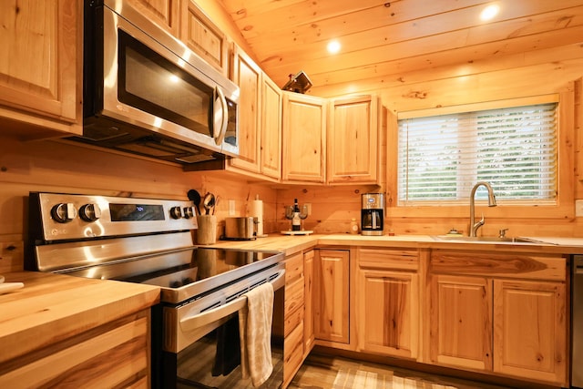 92 Cottage Shore Dr, Holden, ME 04429 - kitchen with appliances with stainless steel finishes, wood counters, light brown cabinets, wooden walls, and recessed lighting