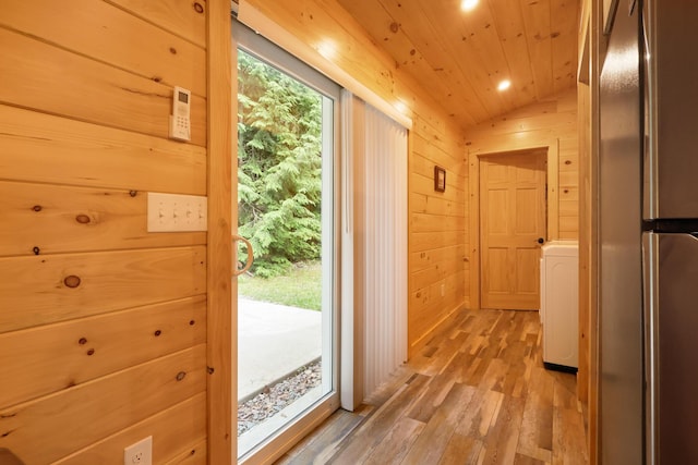 92 Cottage Shore Dr, Holden, ME 04429 - entryway with wooden walls, wood ceiling, lofted ceiling, light wood-style floors, and washer / clothes dryer