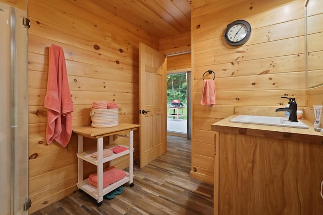 92 Cottage Shore Dr, Holden, ME 04429 - bathroom with wood finished floors, wood walls, wood ceiling, and vanity