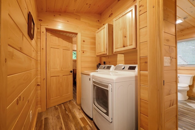 92 Cottage Shore Dr, Holden, ME 04429 - washroom featuring washer and clothes dryer, light wood-style floors, wooden ceiling, wooden walls, and cabinet space