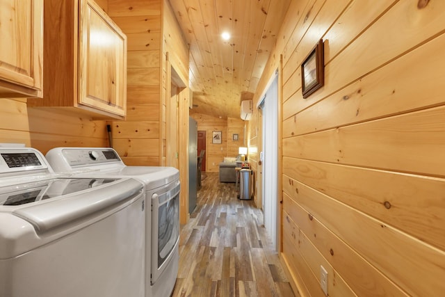 92 Cottage Shore Dr, Holden, ME 04429 - laundry room featuring cabinet space, washing machine and dryer, wooden walls, light wood-style flooring, and wooden ceiling