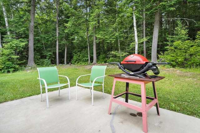 92 Cottage Shore Dr, Holden, ME 04429 - view of patio / terrace featuring a forest view