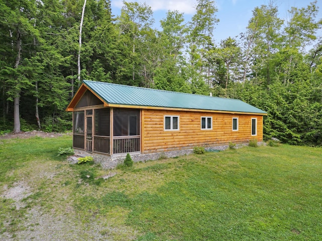 92 Cottage Shore Dr, Holden, ME 04429 - view of property exterior featuring a sunroom, faux log siding, a lawn, and a metal roof