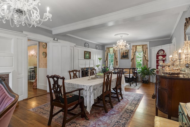 18 High St, Wiscasset, ME 04578 - dining space with a chandelier, wood-type flooring, ornamental molding, a decorative wall, and wainscoting