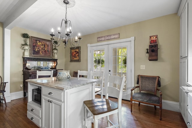 18 High St, Wiscasset, ME 04578 - kitchen featuring a chandelier, dark wood-type flooring, french doors, a center island, and light stone countertops