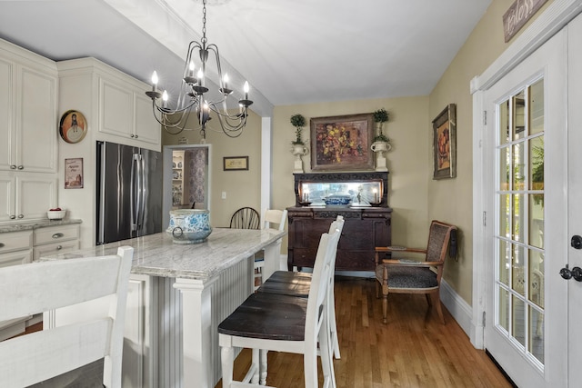 18 High St, Wiscasset, ME 04578 - dining area featuring a chandelier and wood finished floors