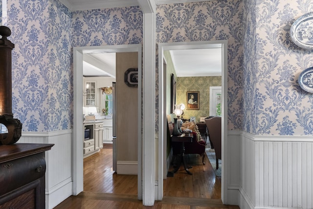 18 High St, Wiscasset, ME 04578 - hall with wallpapered walls, a wainscoted wall, hardwood / wood-style floors, and ornamental molding
