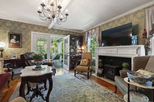 18 High St, Wiscasset, ME 04578 - living area with wallpapered walls, hardwood / wood-style flooring, a chandelier, ornamental molding, and a wood stove