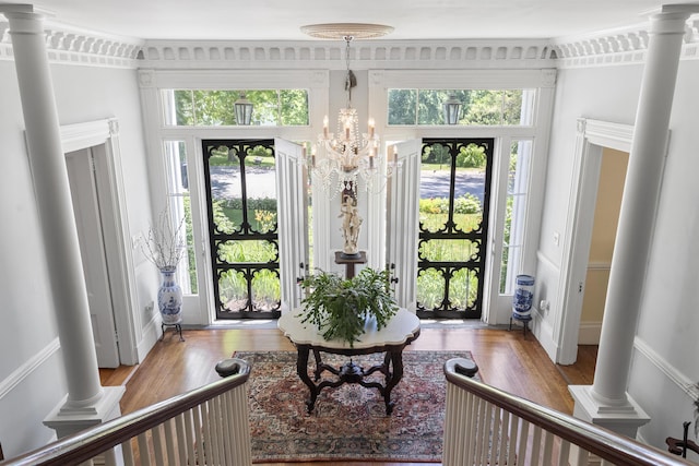 18 High St, Wiscasset, ME 04578 - entrance foyer featuring wood finished floors, ornate columns, and a chandelier