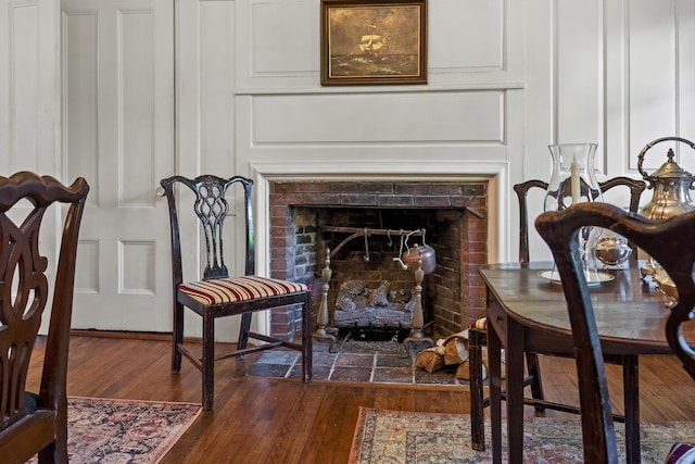 18 High St, Wiscasset, ME 04578 - detailed view of a decorative wall, a fireplace, and wood finished floors