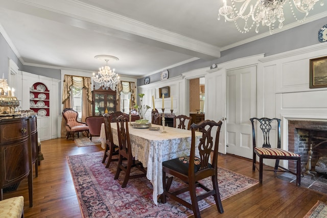18 High St, Wiscasset, ME 04578 - dining space featuring a chandelier, dark wood-style floors, ornamental molding, and a fireplace