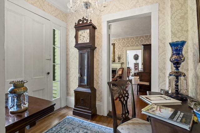 18 High St, Wiscasset, ME 04578 - home office featuring wallpapered walls, wood finished floors, ornamental molding, and a chandelier