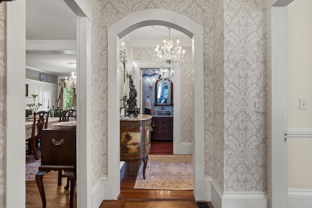 18 High St, Wiscasset, ME 04578 - corridor featuring wallpapered walls, a chandelier, wood finished floors, ornamental molding, and arched walkways
