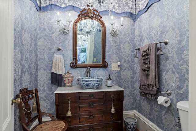 18 High St, Wiscasset, ME 04578 - bathroom featuring wallpapered walls and vanity