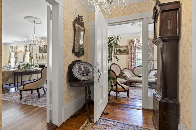 18 High St, Wiscasset, ME 04578 - hallway with a chandelier, crown molding, wood finished floors, and wallpapered walls