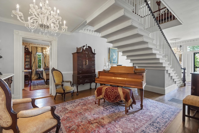 18 High St, Wiscasset, ME 04578 - sitting room featuring stairway, a chandelier, ornamental molding, and wood finished floors