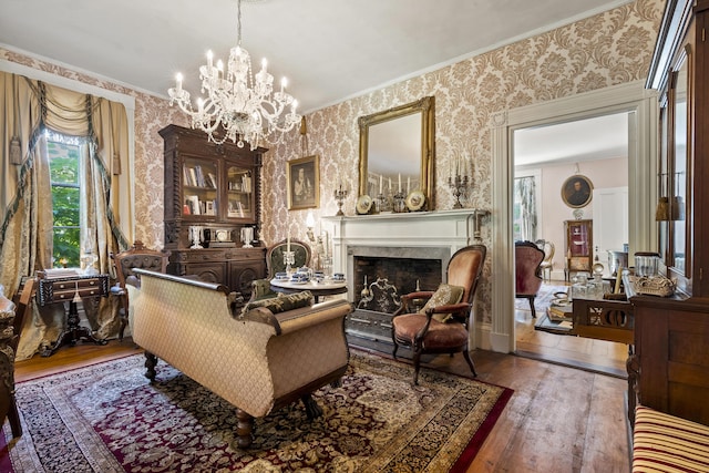 18 High St, Wiscasset, ME 04578 - living area featuring wallpapered walls, wood-type flooring, a chandelier, a high end fireplace, and ornamental molding
